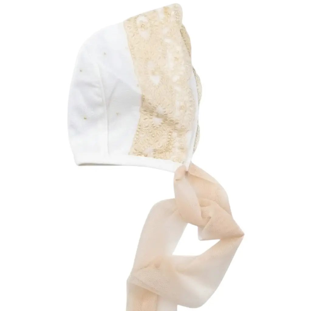 Nanù white baby bonnet with gold macrame lace trim and delicate gold bead embellishments. Features sheer ties.